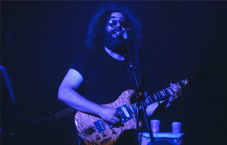Jerry Garcia on stage playing electric guitar.